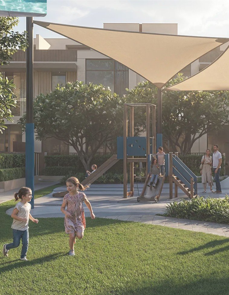 Children playing in a shaded community playground